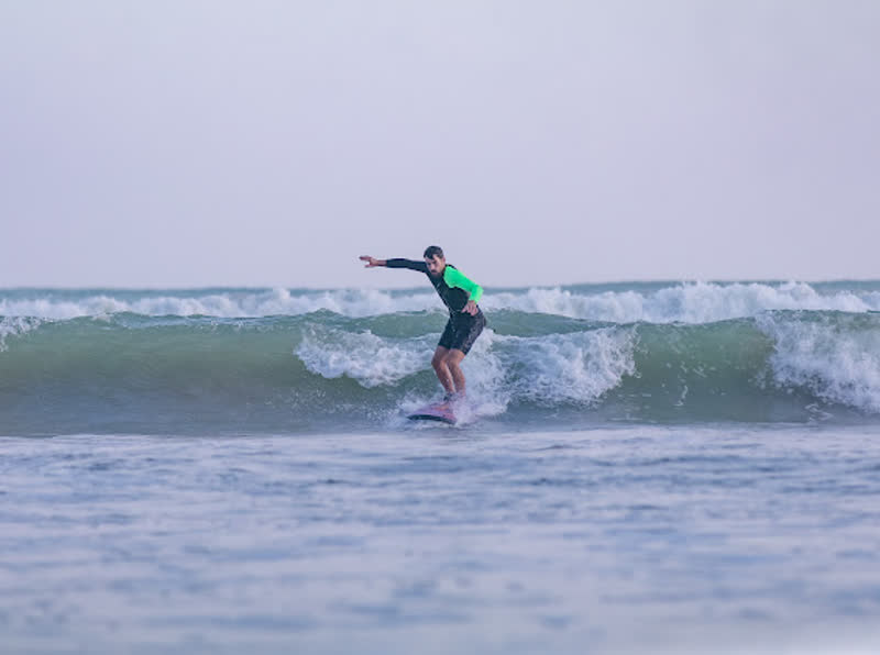 A surfer riding a green wave in Weligama, Sri Lanka